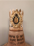 Feather leaf crown with Mary on front encircled with black rhinestones