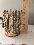 Feather leaf crown with Mary on front encircled with black rhinestones