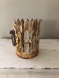 Feather leaf crown with Mary on front encircled with black rhinestones