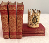 Feather leaf crown with Mary on front encircled with black rhinestones