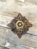 Vintage metal filigree jewelry part with gold flower and rhinestone center