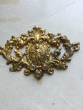 Metal Finding with cherub in center and 3 rhinestones