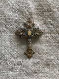 Metal cross with leaf filigree and small Mary on front