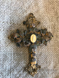 Metal cross with leaf filigree and small Mary on front