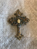 Metal cross with leaf filigree and small Mary on front