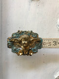 Cherub on a scroll wreath with 3 gold flowers