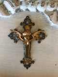 Metal cross with cherub center