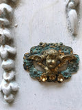 Cherub on a scroll wreath with 3 gold flowers