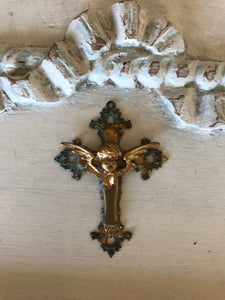 Metal cross with cherub center