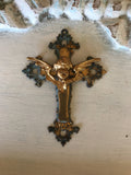 Metal cross with cherub center