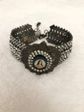 Rhinestone bracelet, embellished rhinestone bracelet and a round mary pendant