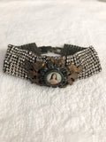 Rhinestone bracelet, embellished rhinestone bracelet and a round mary pendant