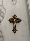 Metal cross with leaf filigree and small Mary on front
