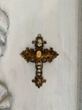 Metal cross with leaf filigree and small Mary on front