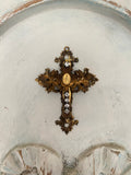 Metal cross with leaf filigree and small Mary on front