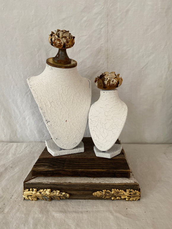 Bust set on old barn wood base with Milk paint washed busts with metal roses