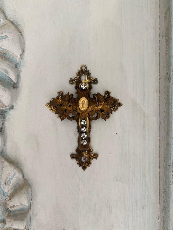 Metal cross with leaf filigree and small Mary on front